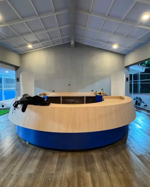 Round reception desk with a wood top and blue base
