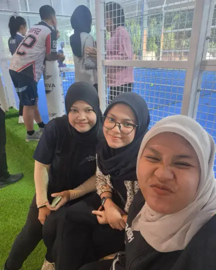 Friends taking a selfie courtside
