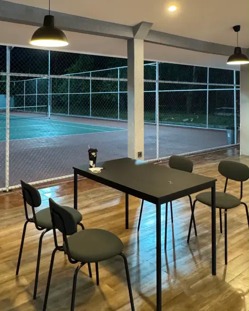 Table and chairs looking out over the tennis courts