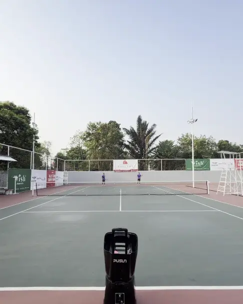Ball machine on a tennis court