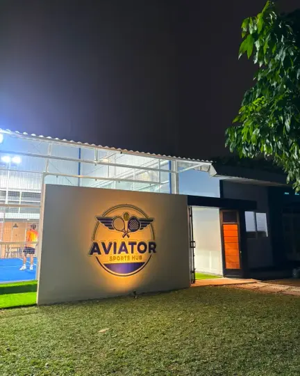 Illuminated Aviator Sports Hub sign at night